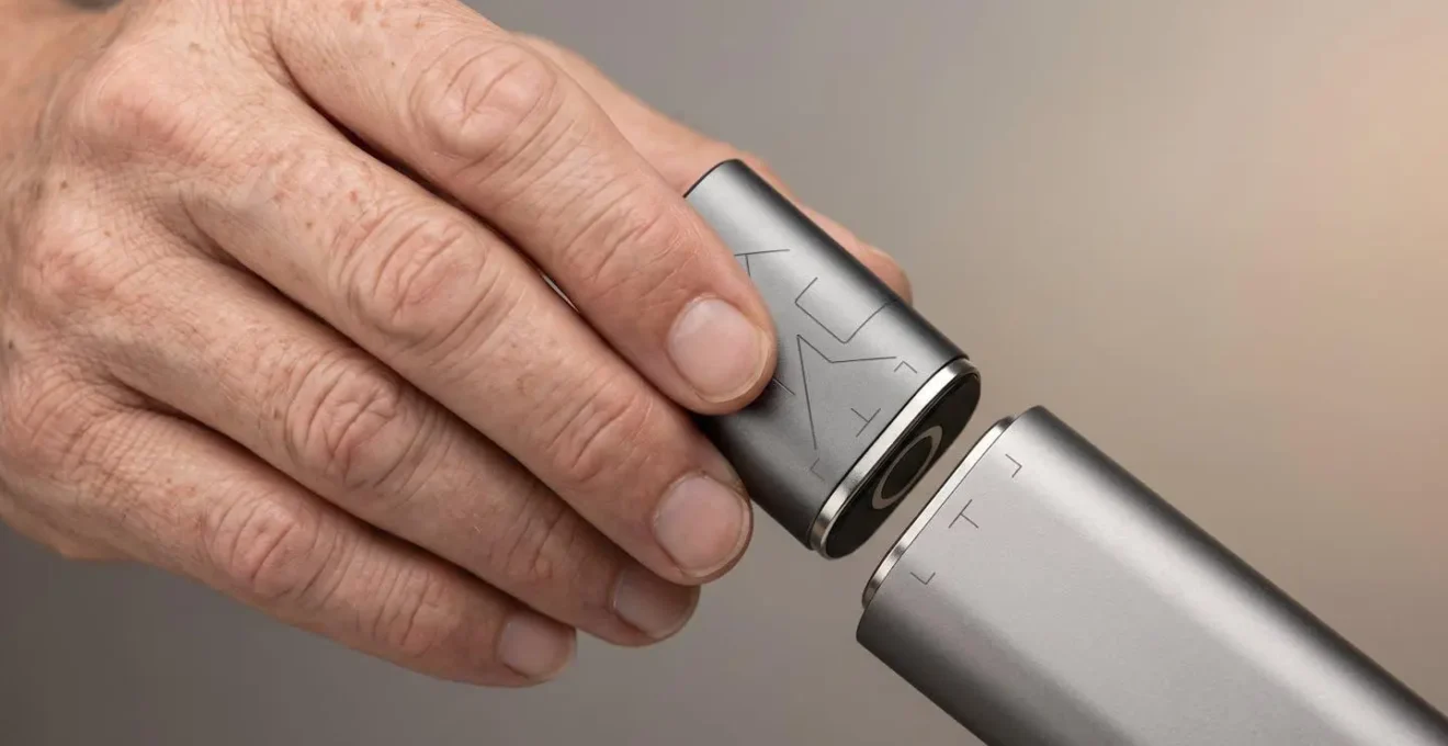 Gros plan sur des mains manipulant délicatement une capsule de pod avec système magnétique
